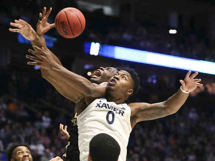 Xavier Musketeers forward Tyrique Jones (0) battles for a rebound against Florida State Seminoles forward Mfiondu Kabengele (25) in the second half of the second-round West Region NCAA tournament game at Bridgestone Arena in Nashville. Xavier lost 75-70.     (Kareem Elgazzar / The Cincinnati Enquirer)